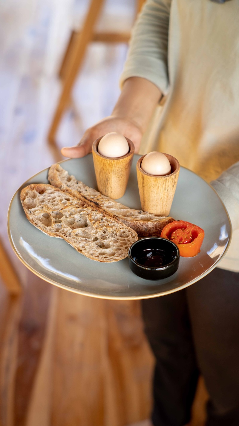 Free range eggs with sourdough bread and roasted tomato